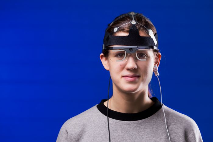 Woman with measuring equipment on her head.