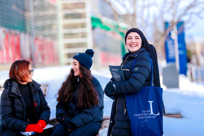 Students talking outside the university building