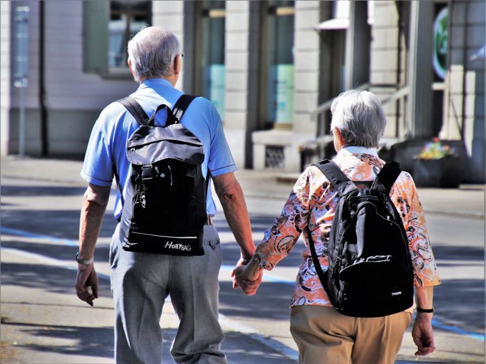 Old man and woman holding hands